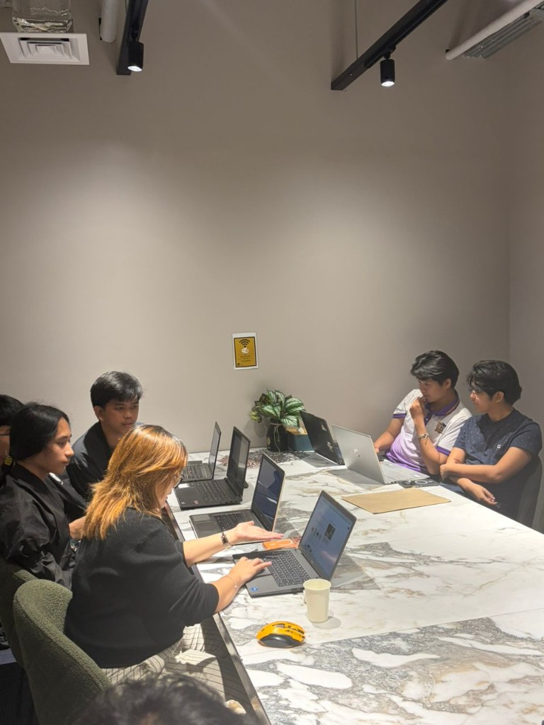 Interns discussing a task during a team session